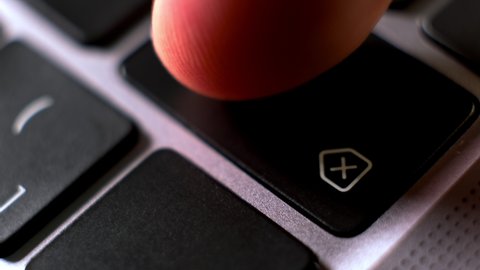 User presses backspace key to delete data on notebook keyboard extreme close view. Person works on computer. Technology advantages