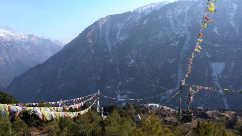 Prayer flags waving in the wind in the mountains of Nepal.