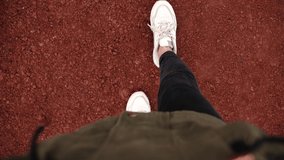 Woman legs in white sneakers walking on red volcanic landscape  - Powered by Shutterstock - Get 15% off with code: PIKWIZARD15