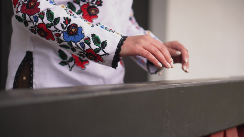 Ukrainian brunette girl in an embroidered shirt walks. Ukrainian national dress.