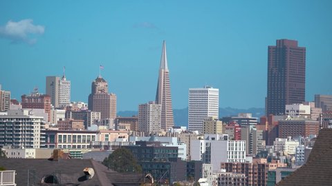 Zoom in shot: Cityscape of San Francisco Downtown with Transamerica Pyramid during sunny day