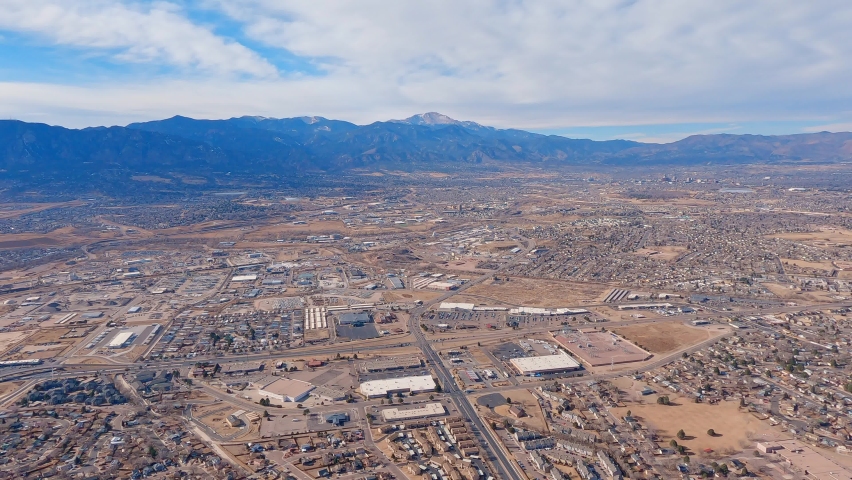 Airplane flight west bound over Colorado Springs towards Pikes Peak and the Rocky Mountains