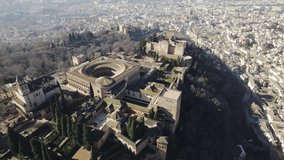 Panoramic view of Alhambra with foggy landscape in background, Granada in Spain. Aerial drone descendent