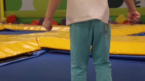 Boys have fun jumping on a children's trampoline, in honor of being born. On a festive day, children relax in the children's playroom cheerfully jumping like acrobats on a real trampoline