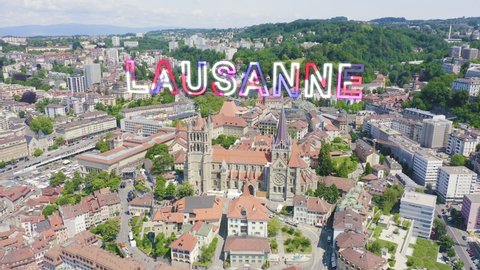 Inscription on video. Lausanne, Switzerland. Cathedral of Lausanne. La Cite is a district historical centre. Glitch effect text, Aerial View, Departure of the camera