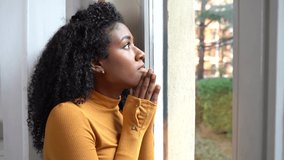 Video about sad young black woman praying and hoping at home