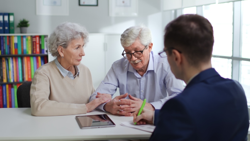 Senior man and woman having meeting with financial adviser. Lawyer consulting aged couple Royalty-Free Stock Footage #1089014691