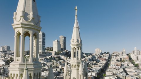 Drone shot of scenic metropolis. Beautiful, cinematic cathedral of Saints Peter and Paul in San Francisco Bay Area with urban cityscape in the background. High quality 4k footage
