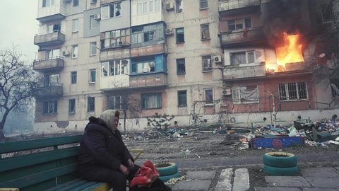 Bucha, Kyiv, Ukraine - 04.04.2022: Terrible footage of the war in Ukraine. Aftermath of the bombing. Unhappy woman crying.