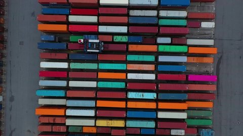 4K Drone shot of modern industrial container port of Hamburg with containers from top view. It is an import and export cargo port where is a part of shipping dock