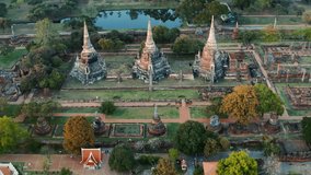 View Forward Aerial shot over 3 stupas of buddhist temple Wat Phra Si Sanphet from above - Ayutthaya, Thailand 01