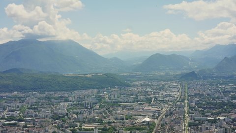 View from the bastille, a fortress that is located in the heights of Grenoble, a city in the French Alps. Time Lapse. Filmed in the summer, cloudy sky.