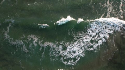 Top down view of stormy sea waters forming wave foam. 4K Drone Video of huge sea waves texture in summer season