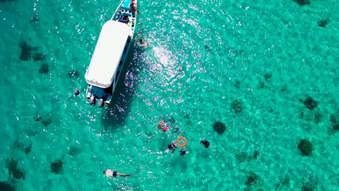 Aerial Drone Shot of Boat with Snorkelers out on the coral reef in Menjangan island, Bali, Indonesia