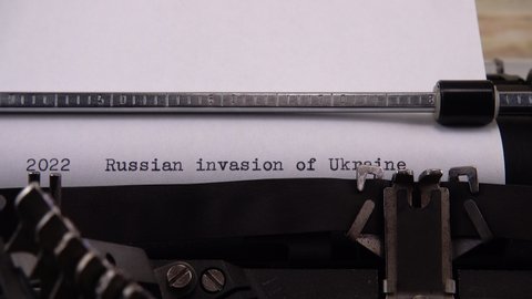 Typing phrase "2022 Russian invasion of Ukraine" on retro typewriter.
