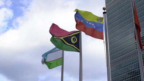 Venezuela, Vanuatu and Uzbekistan flag flying in the wind at United Nations in New York City. Slow motion flags waving