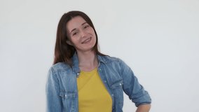 Beautiful woman looking at camera, smiling on white background. Caucasian portrait, cute brunette with braces smile, posing in studio. Isolated happy feminine. Positive adult girl. Copy space for text - Powered by Shutterstock - Get 15% off with code: PIKWIZARD15