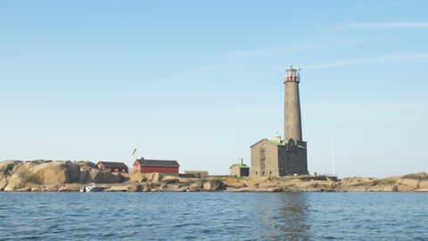 Grey lighthouse made of stone in a isolated rocky island on the coast of Finland.