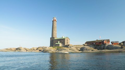 Historical lighthouse made of stone filmed from aing boat