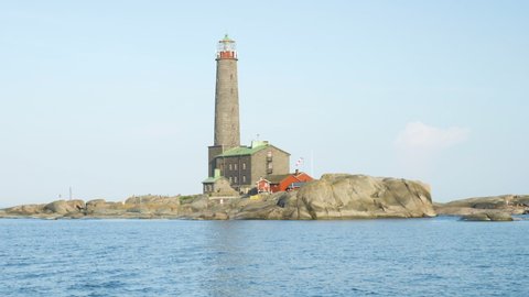 Historical lighthouse made of grey stone in finnish archipelago