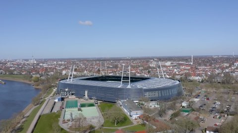 Bremen, Germany - March 2022: Day transferring into night and Weserstadion lights up for SV Werder Bremen Bundesliga home match.