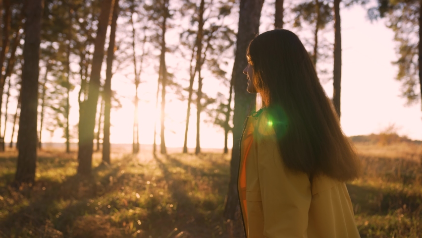 Girl walks through natural forest. Woman hiking alone. Teenager girl in nature at sunset. Fantasy of people in park in autumn. Active lifestyle. People in forest. Tourist walk in autumn forest park Royalty-Free Stock Footage #1089033833