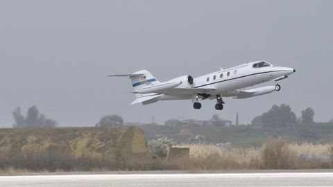 Andravida Greece APRIL, 1, 2022 Luxury business jet used by United States Air Force take off in a grey cloudy day. Gates Learjet 35 C-21A of USAFE used for transport of passengers, cargo and litters