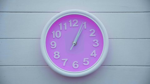 Time laps wall pink clock move quickly. Time is running out