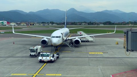 Bergamo International Airport. Loading or unloading passenger luggage on the plane before departure at the terminal. Aerodrome equipment. Boeing Ryanair. Tourism. Transport. Milan Italy April 2022