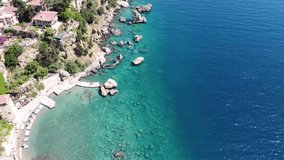 Panoramic view of a beautiful coastline with five star hotels on a cliff. Top view of the Antalya city and beach among the rocks. Tourist season in Turkey 