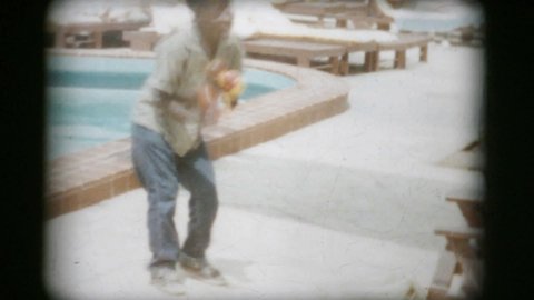SILVER SPRINGS, FLORIDA, MARCH, 1960: A young energetic African American street performer shows his moves while dancing on the street in 1960.