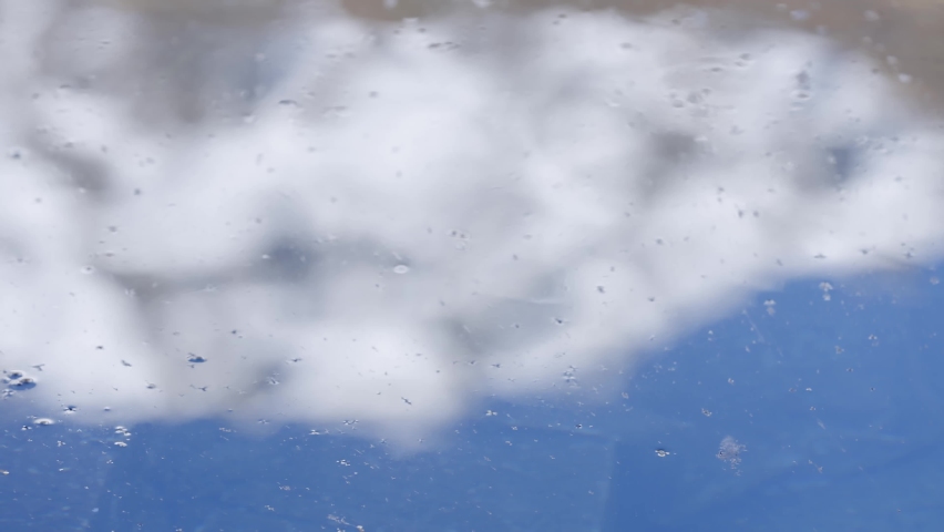 Snow Covered Mountain And Blue Sky Reflecting On Rippling Water On A Sunny Day. Kedarnath Mountain In Uttarakhand, India. close up