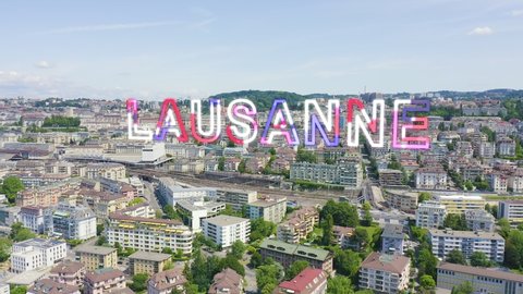 Inscription on video. Lausanne, Switzerland. Flight over the central part of the city. La Cite is a district historical centre. Glitch effect text, Aerial View