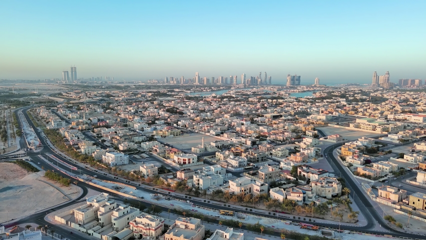 Doha, Qatar: Aerial view of capital city of Qatar, cityscape with skyscrapers skyline of Lusail district on horizon - landscape panorama of Arabian Peninsula from above, West Asia