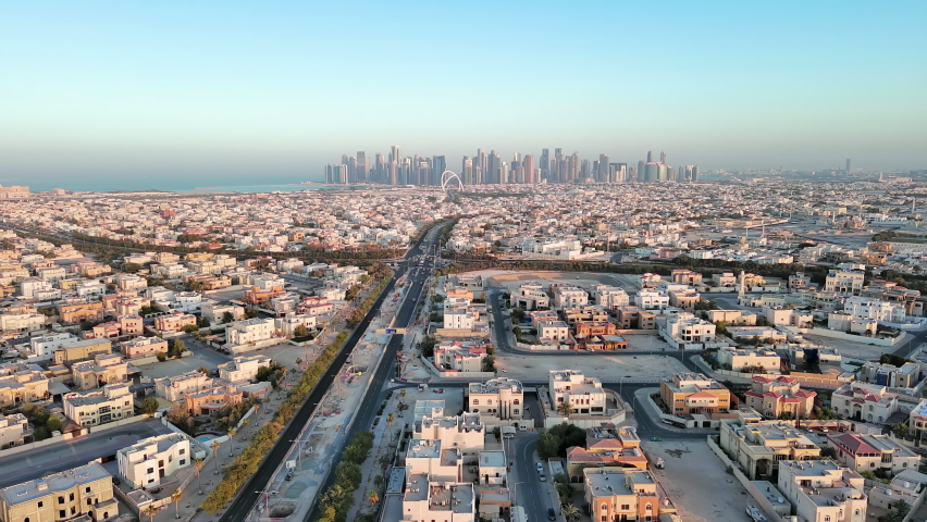 Doha, Qatar: Aerial view of capital city of Qatar, cityscape with skyscrapers skyline of West Bay site on horizon - landscape panorama of Arabian Peninsula from above, West Asia Royalty-Free Stock Footage #1089051915