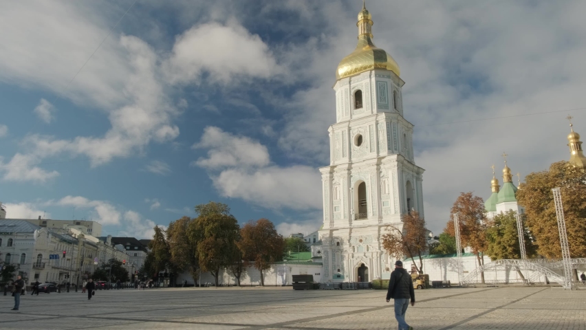 Man walking across Sophia Square towards Bell tower of Saint Sophia Cathedral, Kyiv in 2021