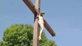 Huge wooden cross as the crucifixion with Jesus figure