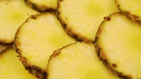 Fresh Pineapple Slices, Juicy Halves Tropical Fruit, Closeup. Isolated Yellow Pineapple Slices Rotate. Pineapple Diet for Weight Loss. Vegetarian food. Healthy Vitamin Food.