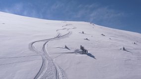 Drone 4k video with ski touring skiers in Bucegi Mountains on a beautiful sunny day skiing in powder snow
