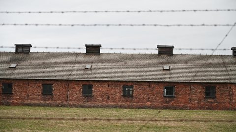 Auschwitz, Poland, March 2022: Auschwitz concentration and extermination camp. Barracks in concentration camp. Nazi death camp. Barbered wire. 