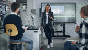 Female Student Asking her Teacher while she Explaining Using Robot Arm at the Lesson. Diverse Group of Young Engineers Programming Robotic Hand. Computer Science Concept - Powered by Shutterstock - Get 15% off with code: PIKWIZARD15