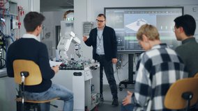 University Robotics Class. White Male Teacher Explaining Engineering to Students Using Robot Arm. Diverse Group of Young Engineers Sitting at University. Computer Science Education Build, Design - Powered by Shutterstock - Get 15% off with code: PIKWIZARD15