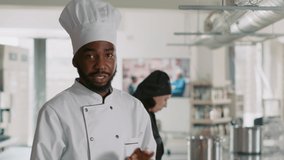 POV of african american chef filming cooking show with camera, learning gastronomy dish preparations on online class. Authentic cook broadcasting culinary content in ktichen. Handheld shot. - Powered by Shutterstock - Get 15% off with code: PIKWIZARD15