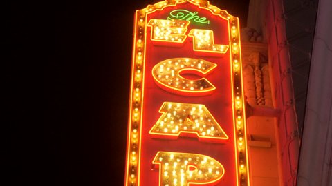 Los Angeles, California, US - April 2022. El Capitan Theatre (movie palace). Walk of Fame by night, Hollywood Boulevard (Blvd). Beautiful professional vertical pan tripod shot.