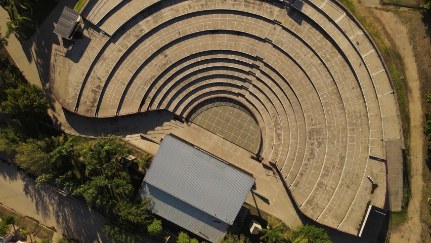 Aerial top down shot of empty amphitheater with stage during sunny day - Villa Maria in Cordoba,Argentina.