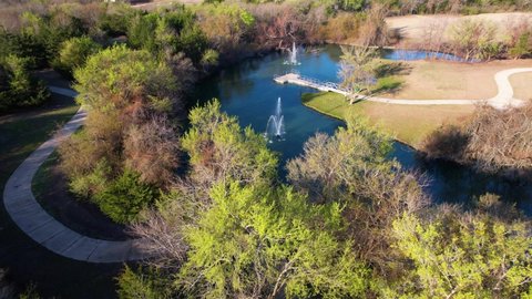 Pond in Natural Springs Park in Anna Texas with 2 fountains.