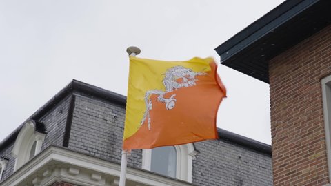 Bhutan Flag waving during snowfall in winter - Slow Motion