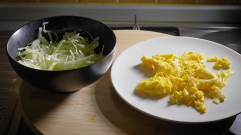 Scrambled Eggs, Bowl With Sliced Cabbage and Toast Presented on Table