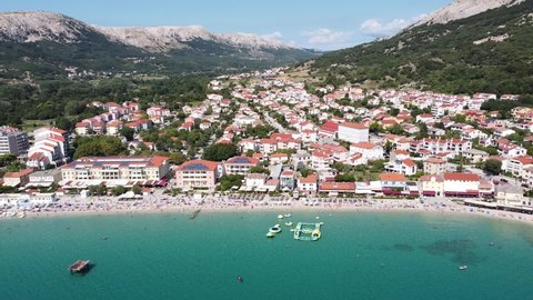 Baska Beach, Krk island, Croatia - Aerial Drone View of the Seaside Resort with Coastline, Tourists, Boulevard, Sunbeds and Water Playground