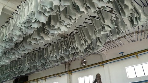 Hides Hanging From Drying Racks In A Leather Production Plant